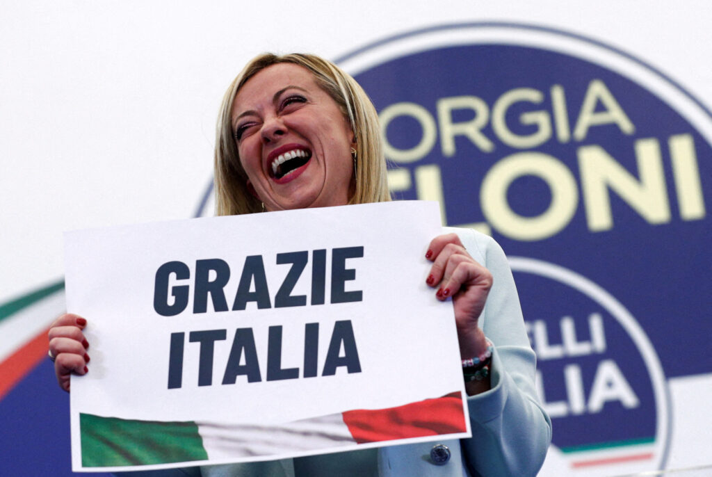 Leader of Brothers of Italy Giorgia Meloni holds a sign at the party's election night headquarters, in Rome, Italy September 26, 2022.