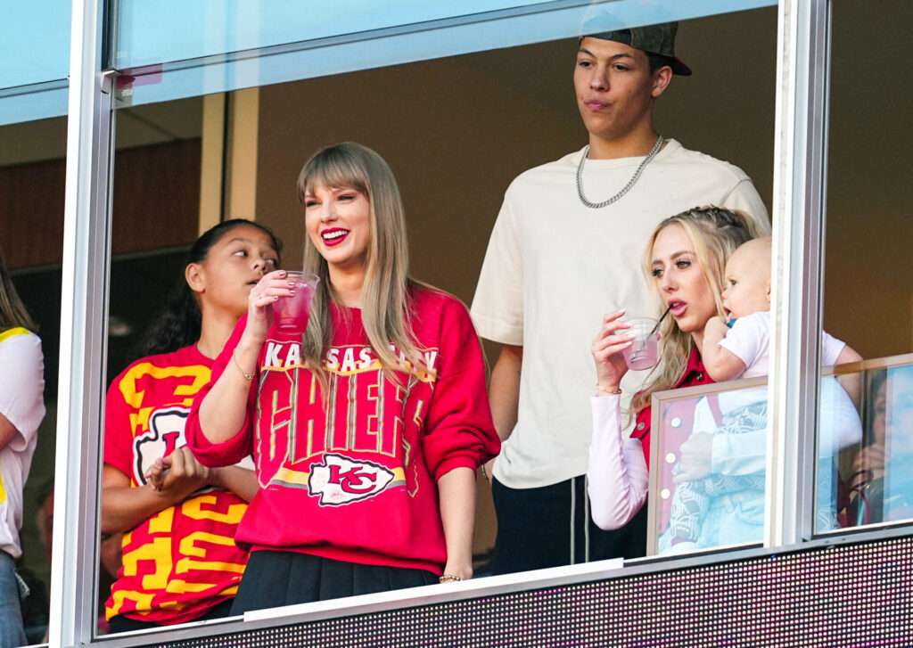 Recording artist Taylor Swift watches the action with Jackson Mahomes and Brittany Mahomes during the first half at GEHA Field at Arrowhead Stadium.