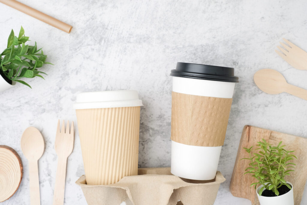 The biodegradable coffee cup with and cup holder. Recycled and sustainable to-go or take-away package for food and drink packaging.
